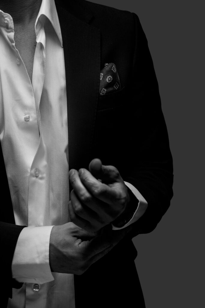 part-black-white-portrait-male-suit-dark-grey-background-scaled